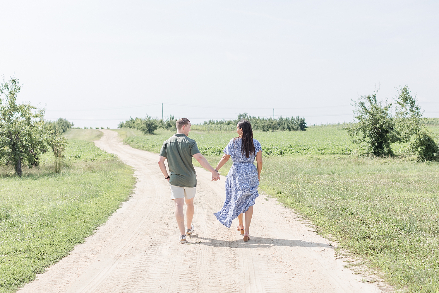 couple walk together holding hands 