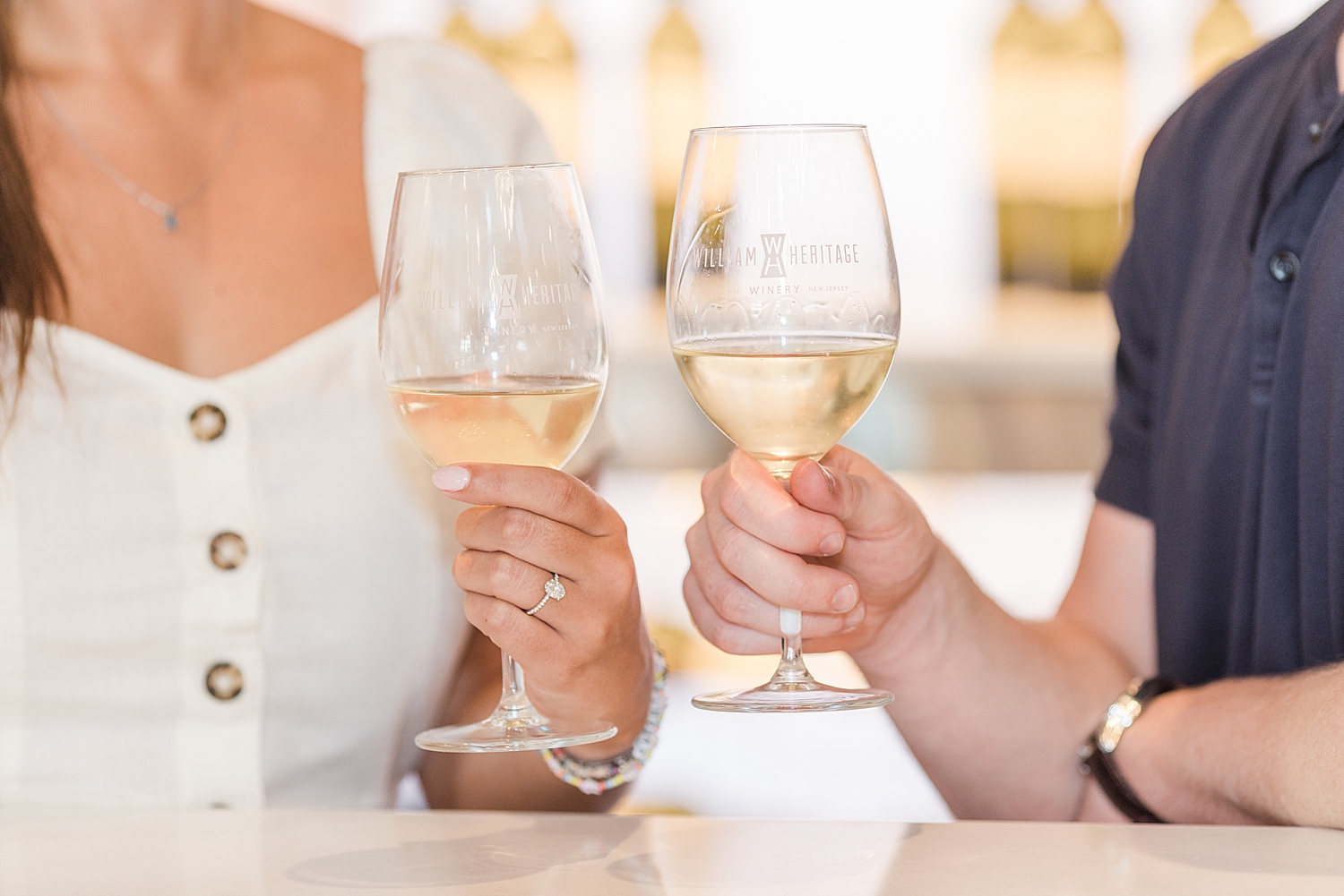 couple enjoy glass of wine during engagement session