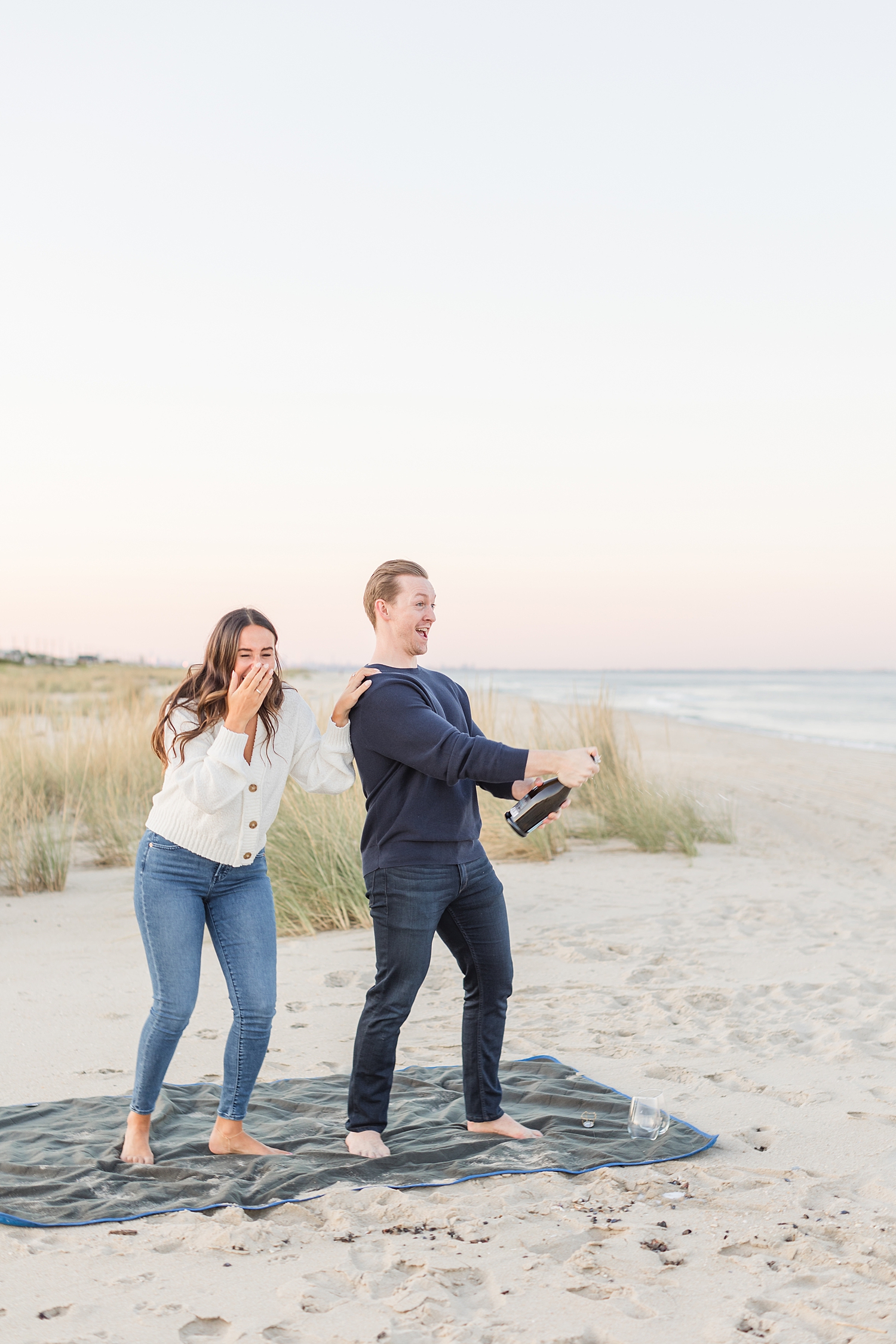 couple pops champagne at New Jersey engagement session