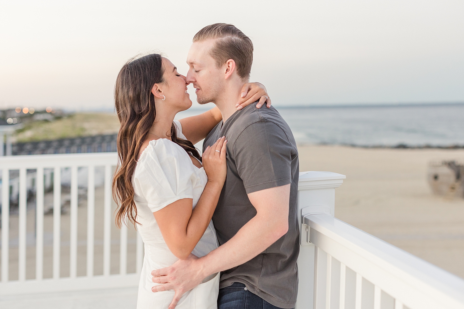 engagement photos on balcony overlooking the ocean