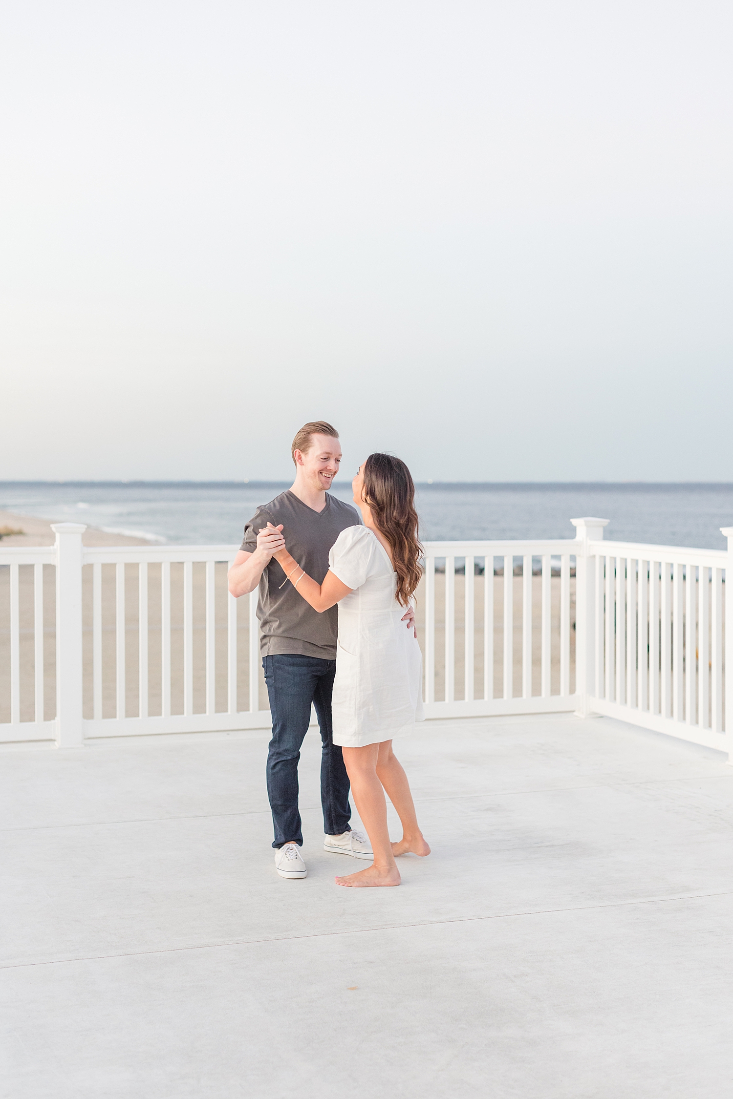 romantic engagement photos of couple dancing on balcony