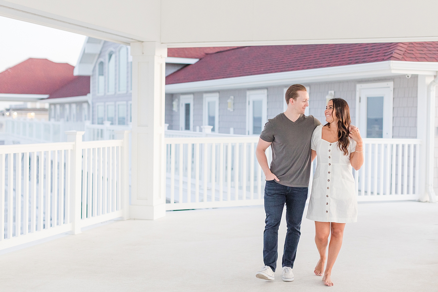 couple walk together on balcony 