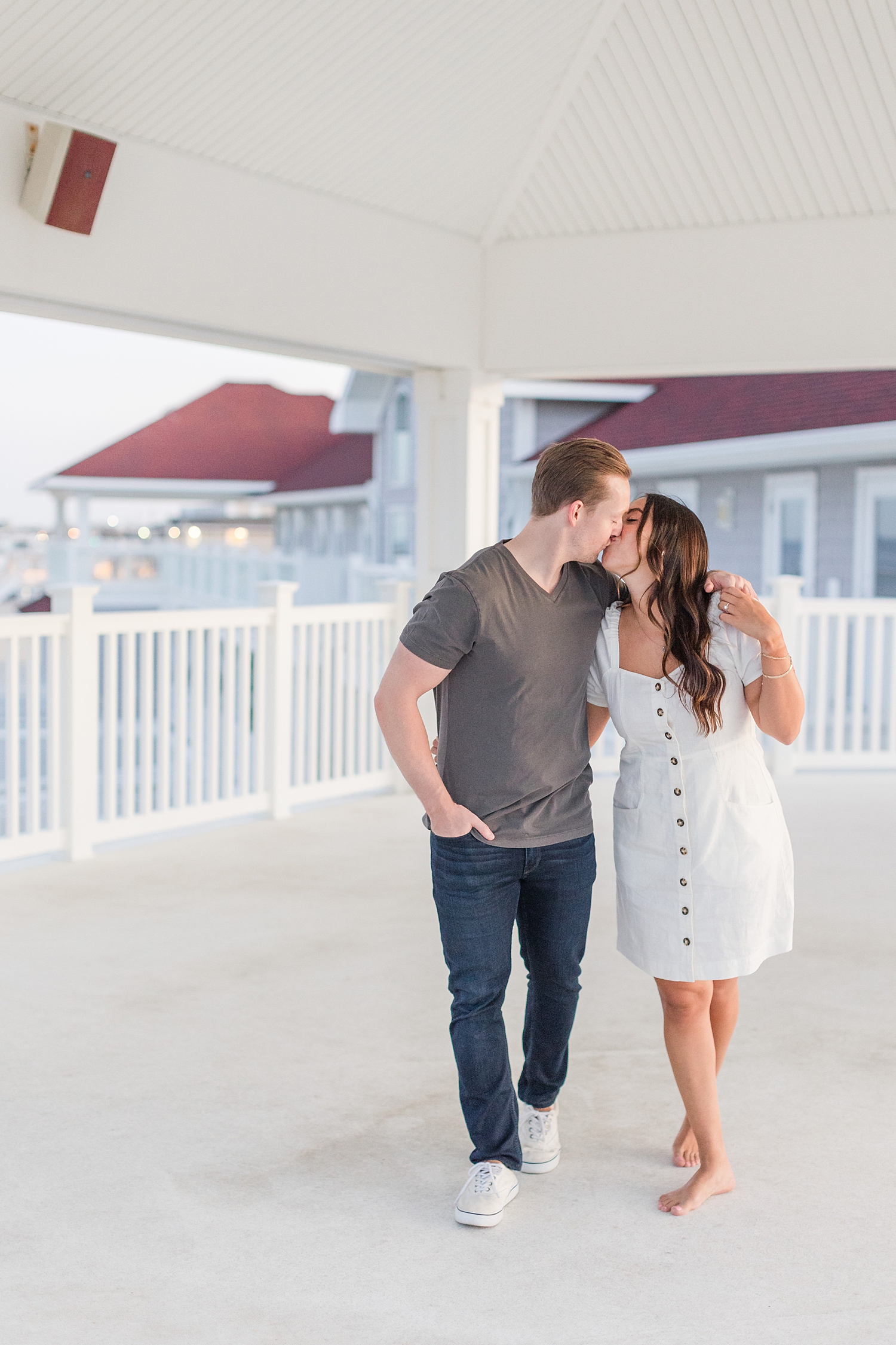 couple kiss as they walk together 