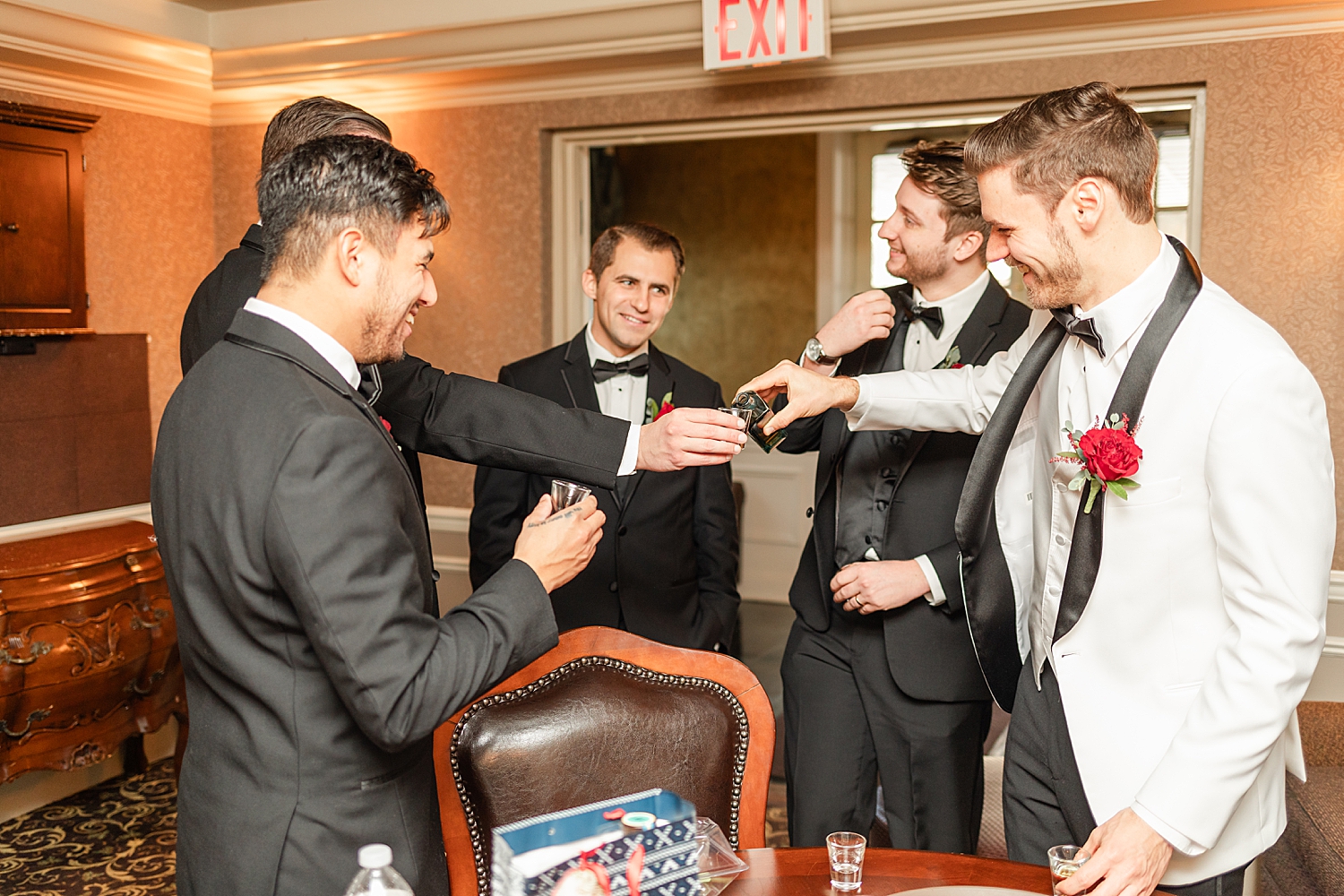 groom and groomsmen have a toast