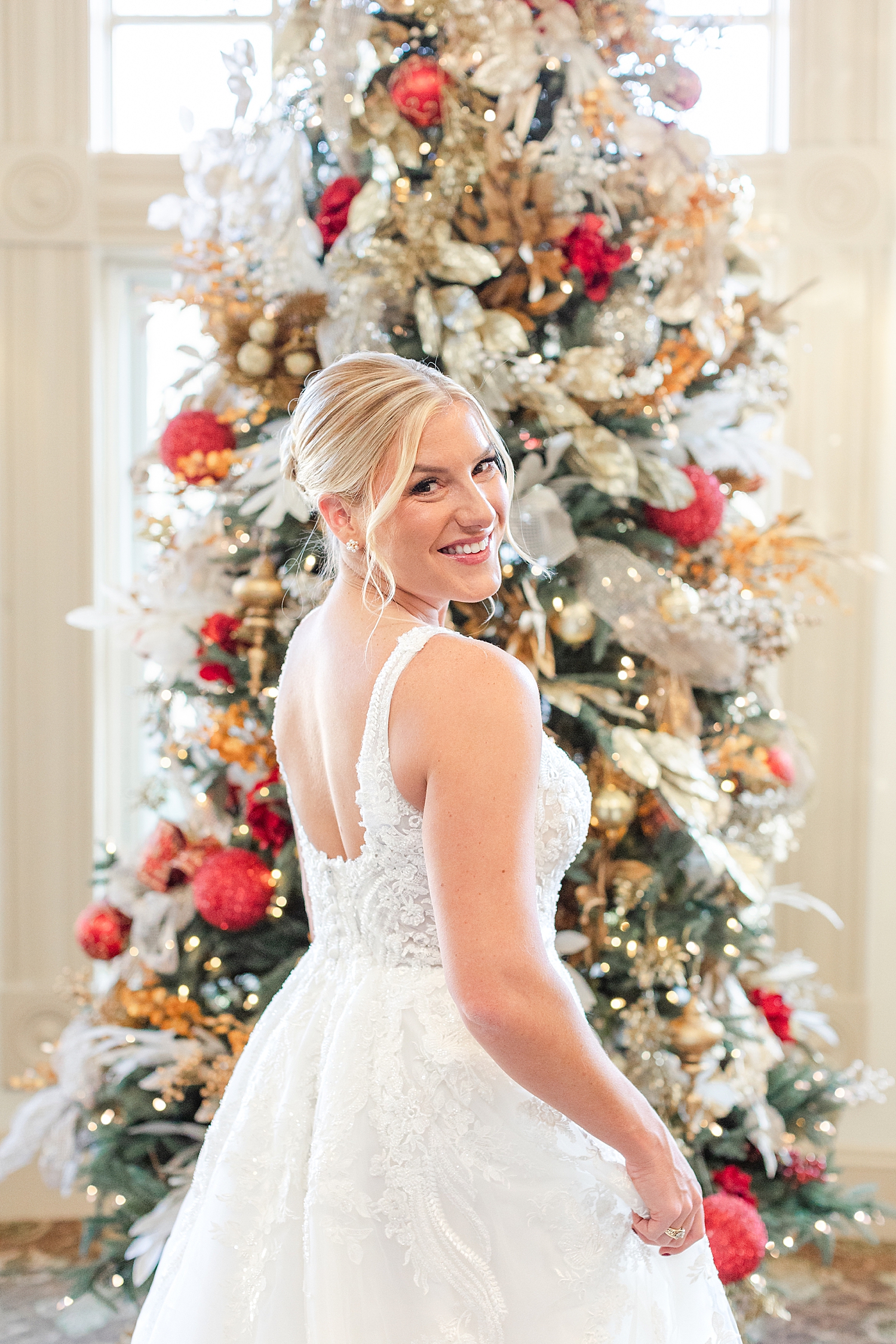 bridal portraits in front of Christmas tree from Festive Holiday Wedding in New Jersey