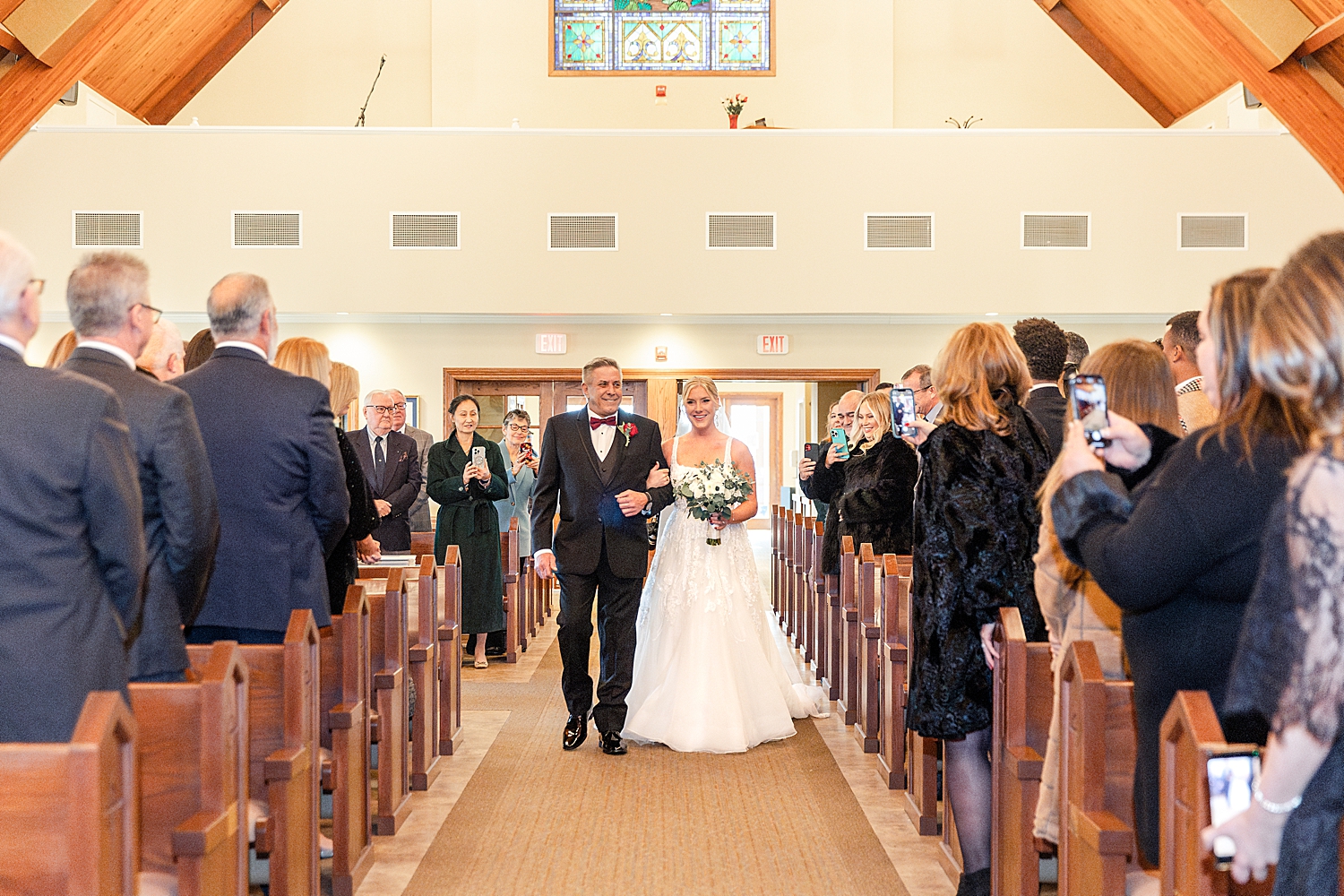 bride walking down aisle with father