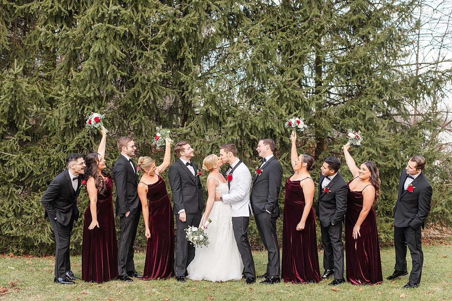 newlyweds kiss as wedding party cheers