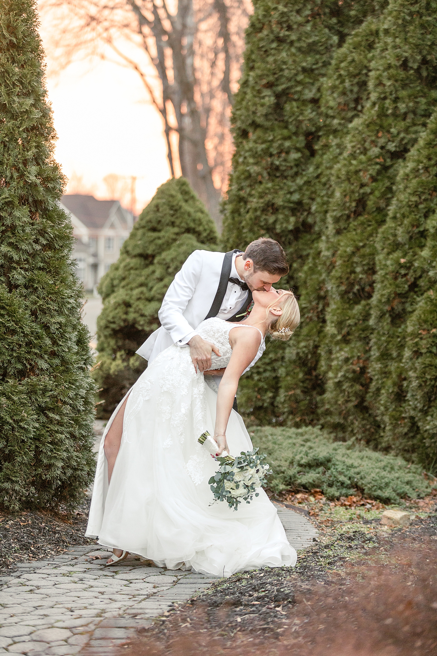 romantic wedding photos of groom kissing his bride