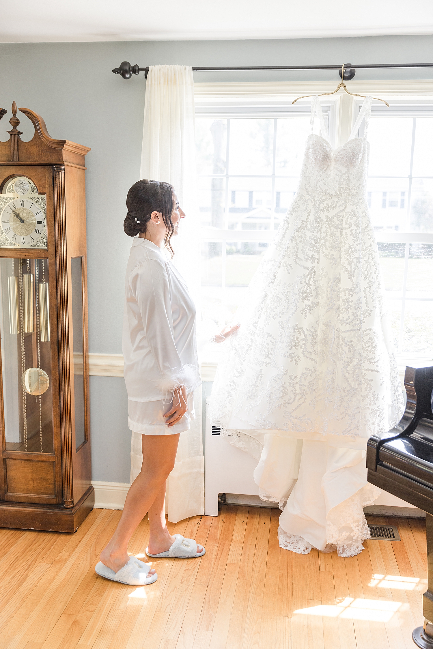 bride looks at wedding dress