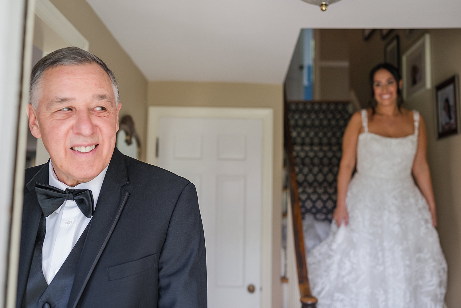 bride walks down stairs to surprise dad during first look