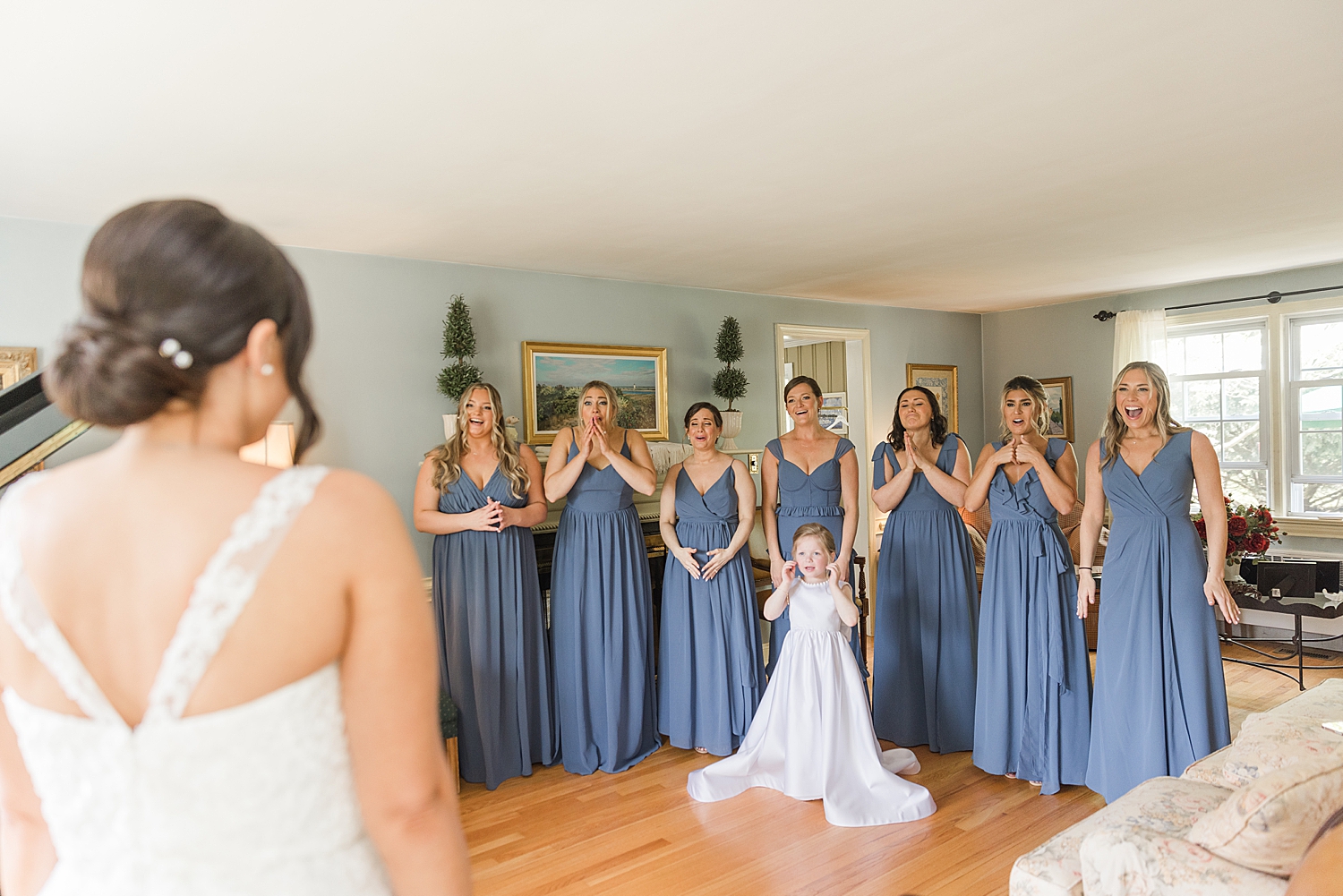 bridesmaids in steel blue bridesmaids dresses react to seeing bride for the first time