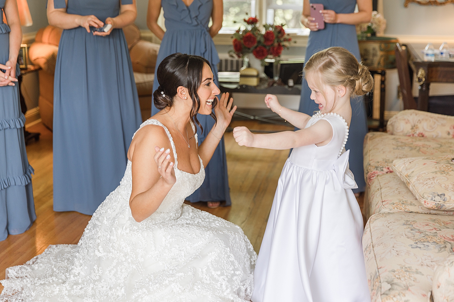 candid moments between bride and flower girl