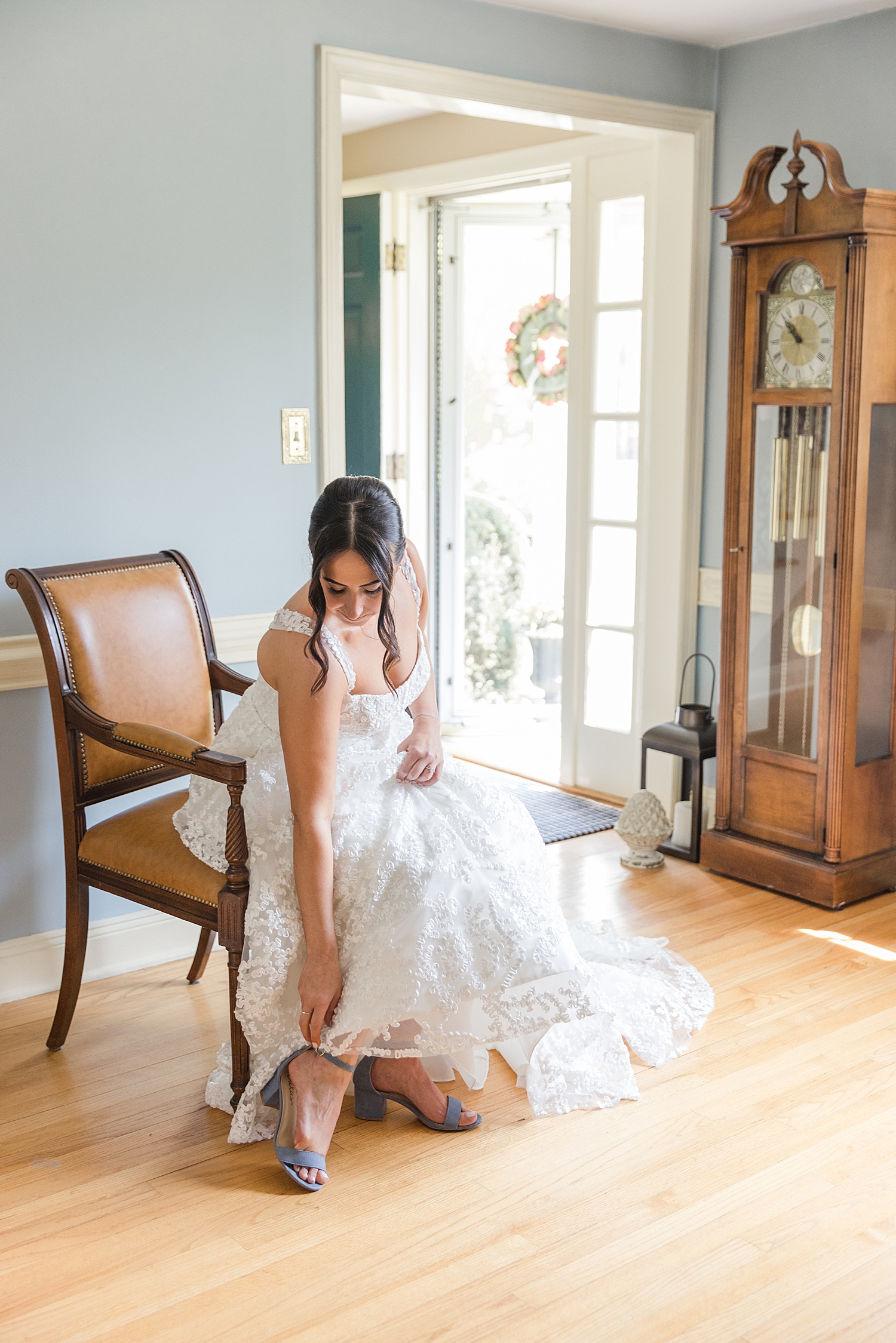 bride puts wedding shoes on