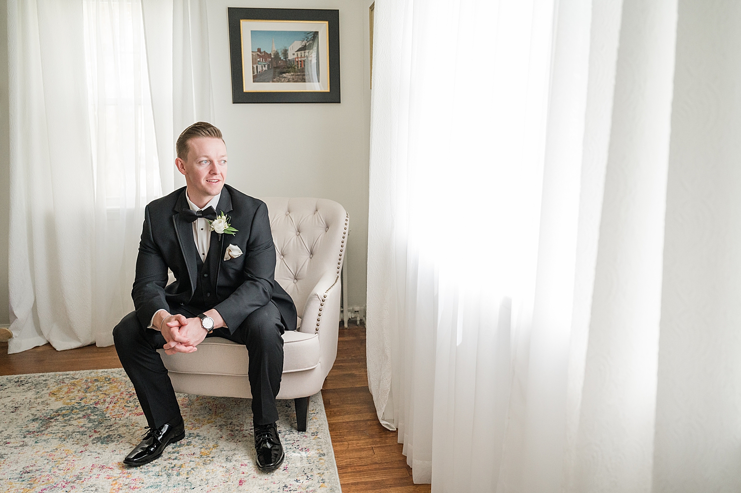 groom sits in chair 