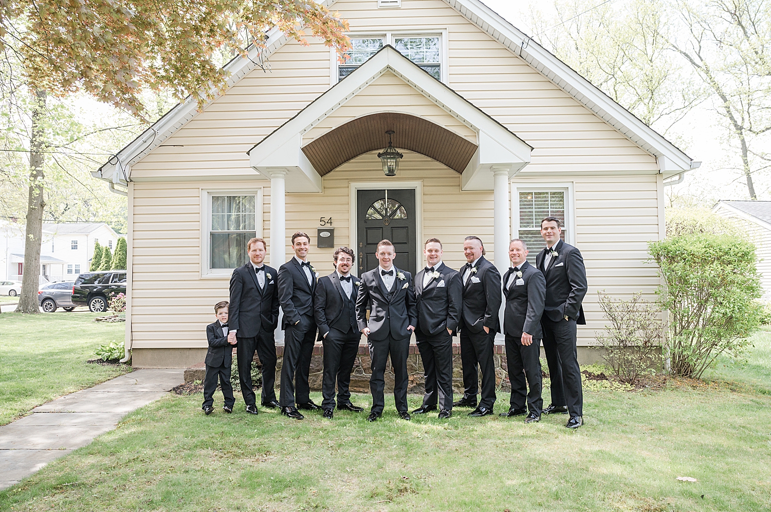 groom and groomsmen photos outside of house