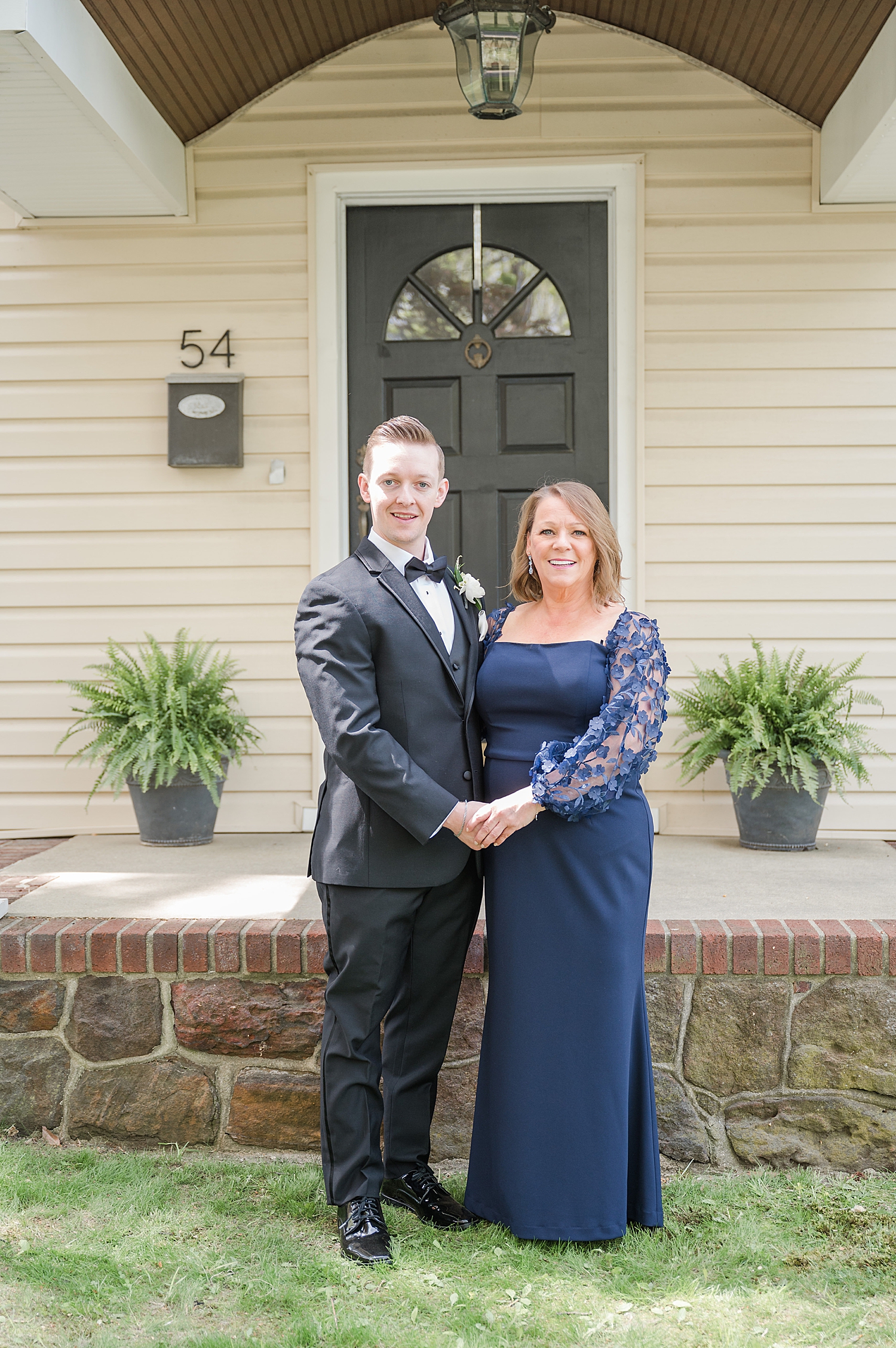 groom with mom outside of house