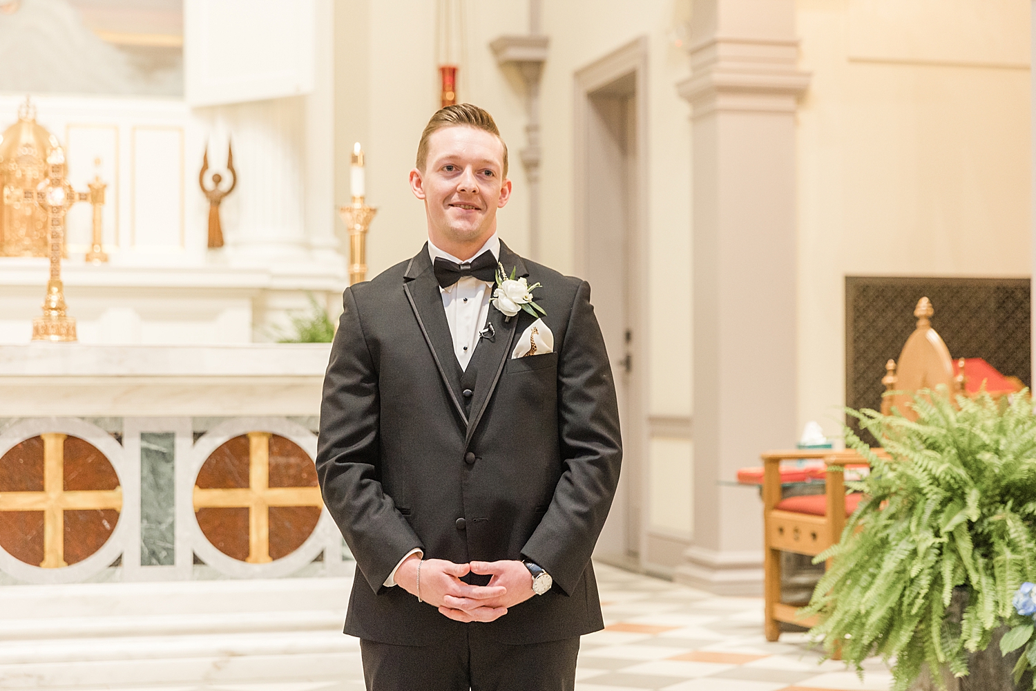 groom smiles as he watches his bride