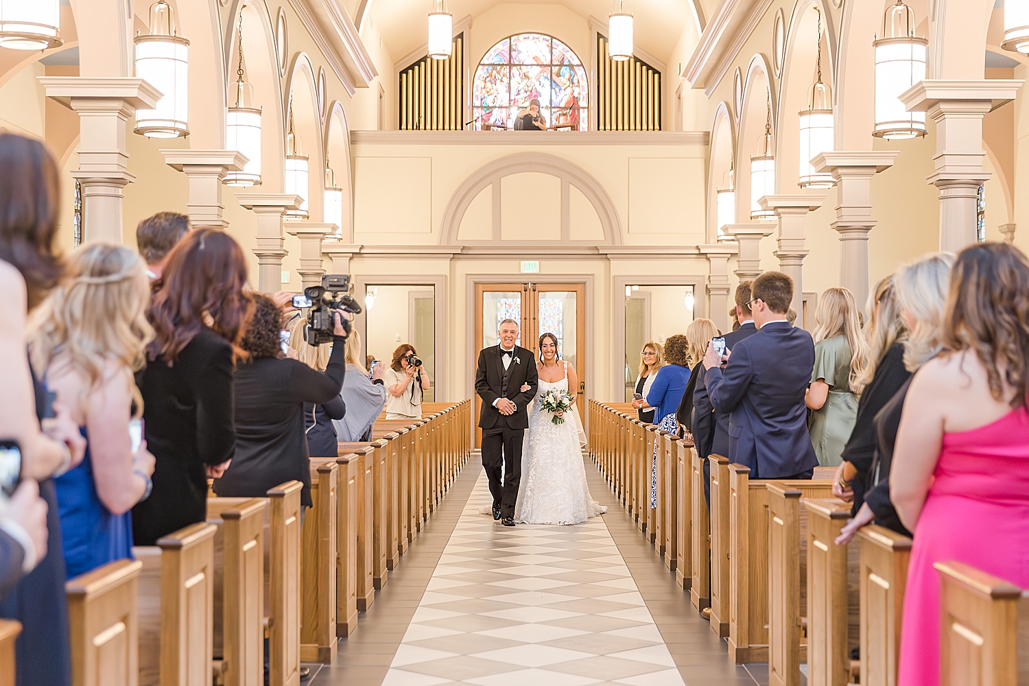 bride walking down aisle at church wedding ceremony 