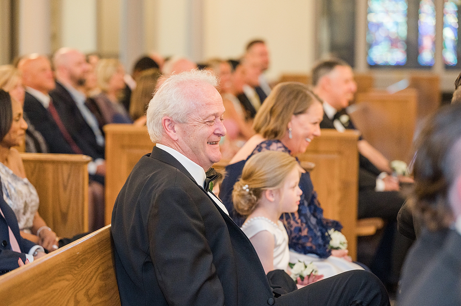 wedding guests smile during wedding ceremony