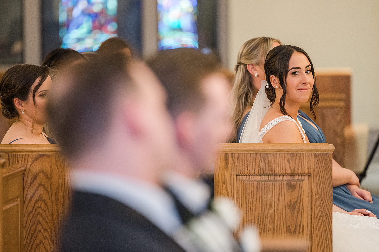 bride and groom steal a glance at each other during wedding ceremony 