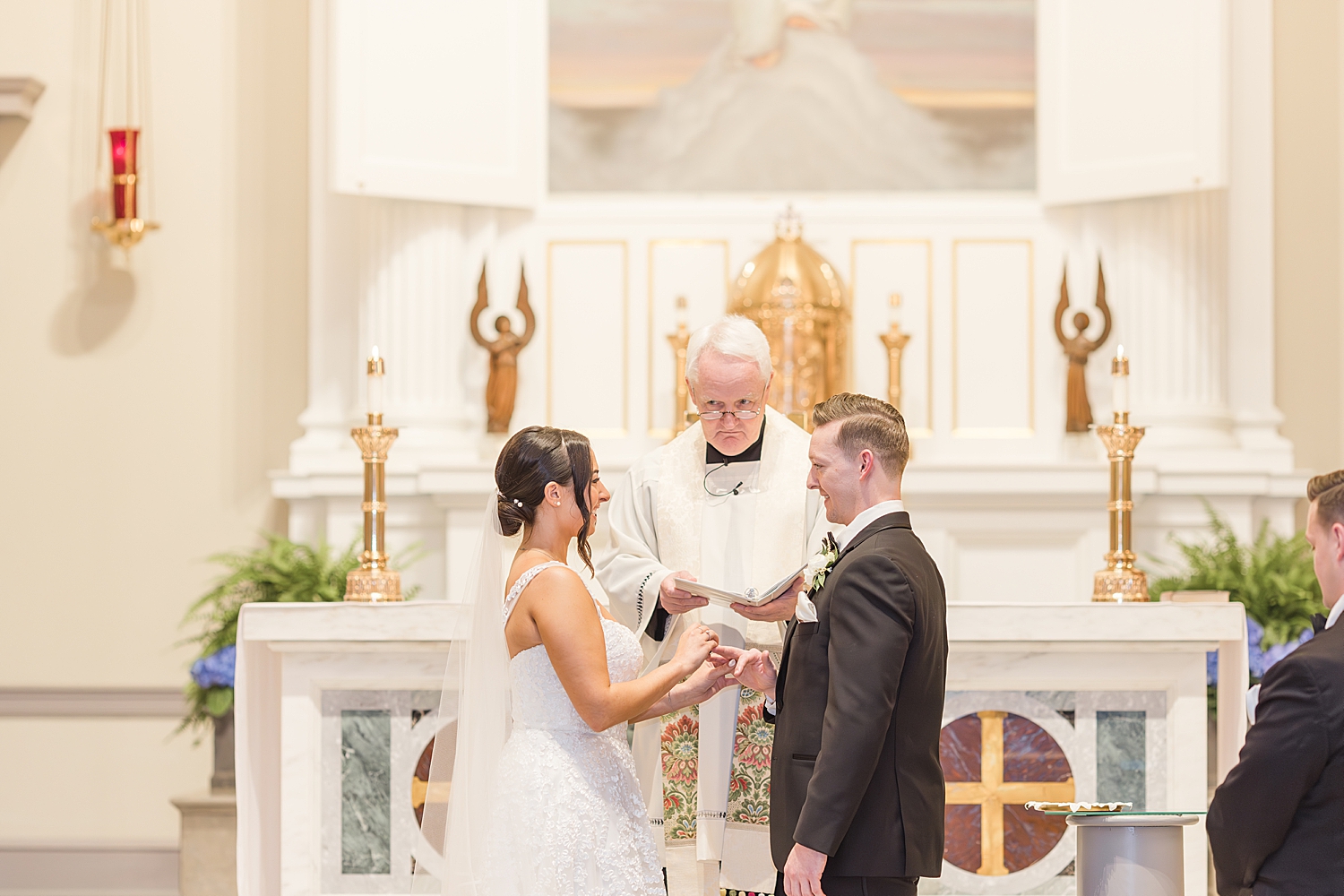 bride and groom exchange wedding rings