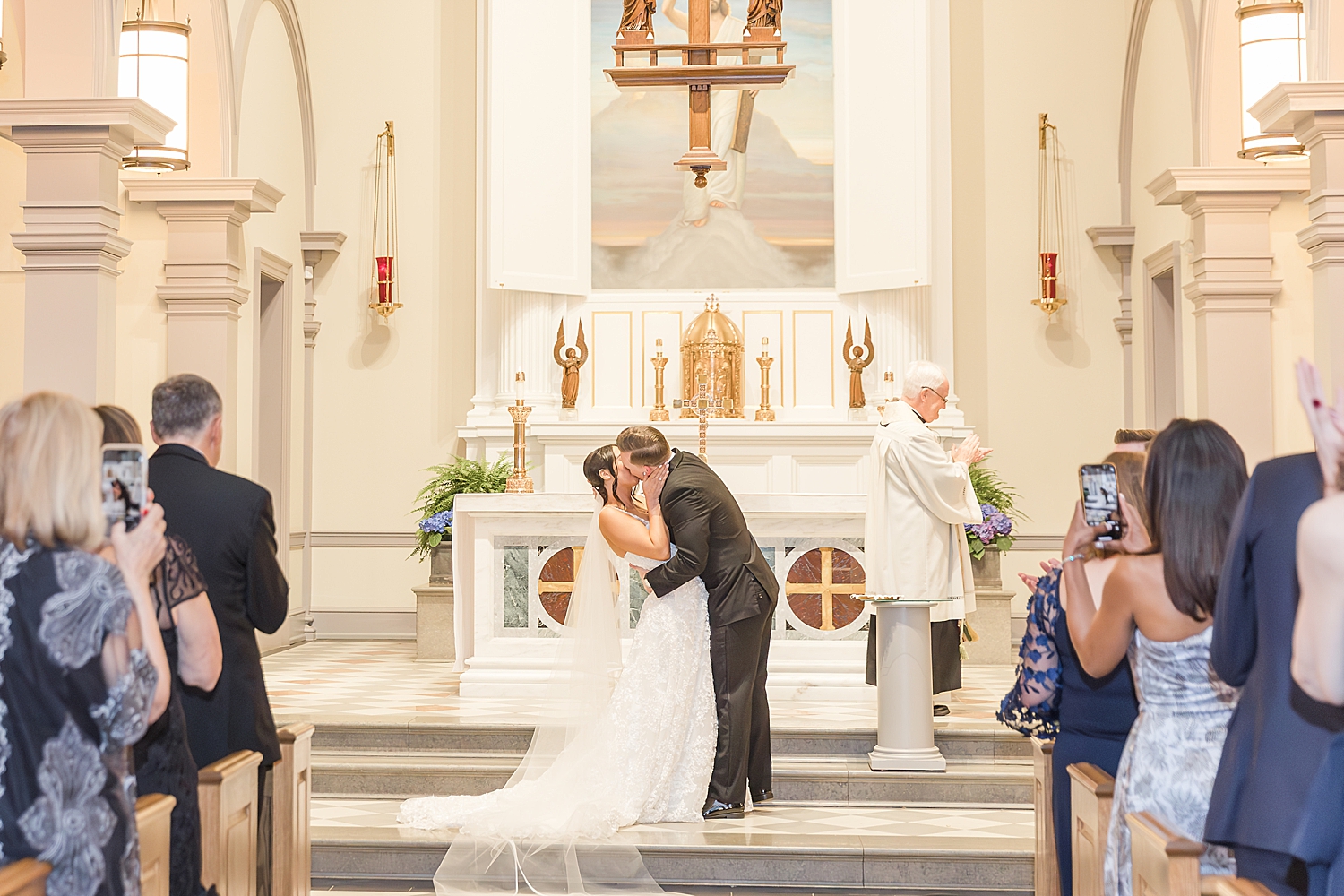 bride and groom kiss during wedding ceremony