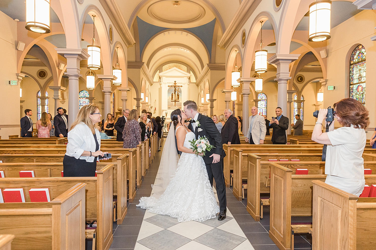 newlyweds kiss in church after ceremoy 