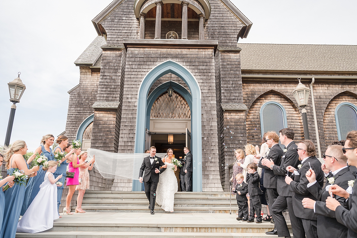 wedding guests blow bubbles during wedding exit