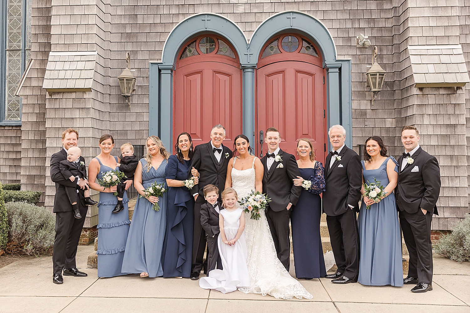 family with bride and groom after wedding ceremony