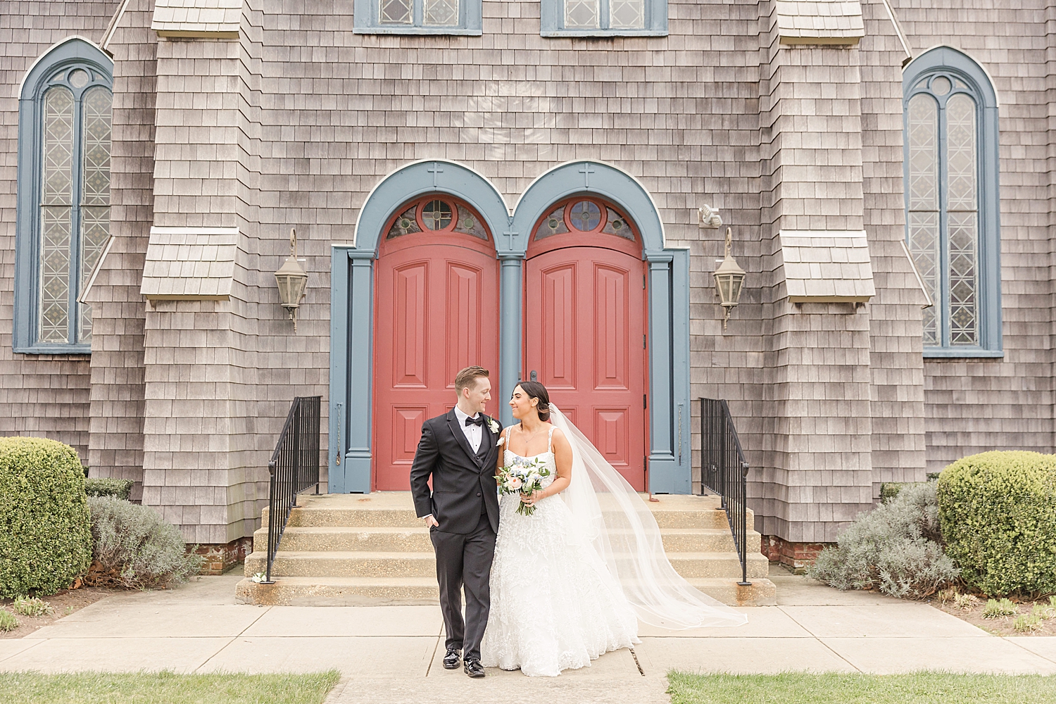 bride and groom walk together outside of church from Romantic Spring Wedding in New Jersey