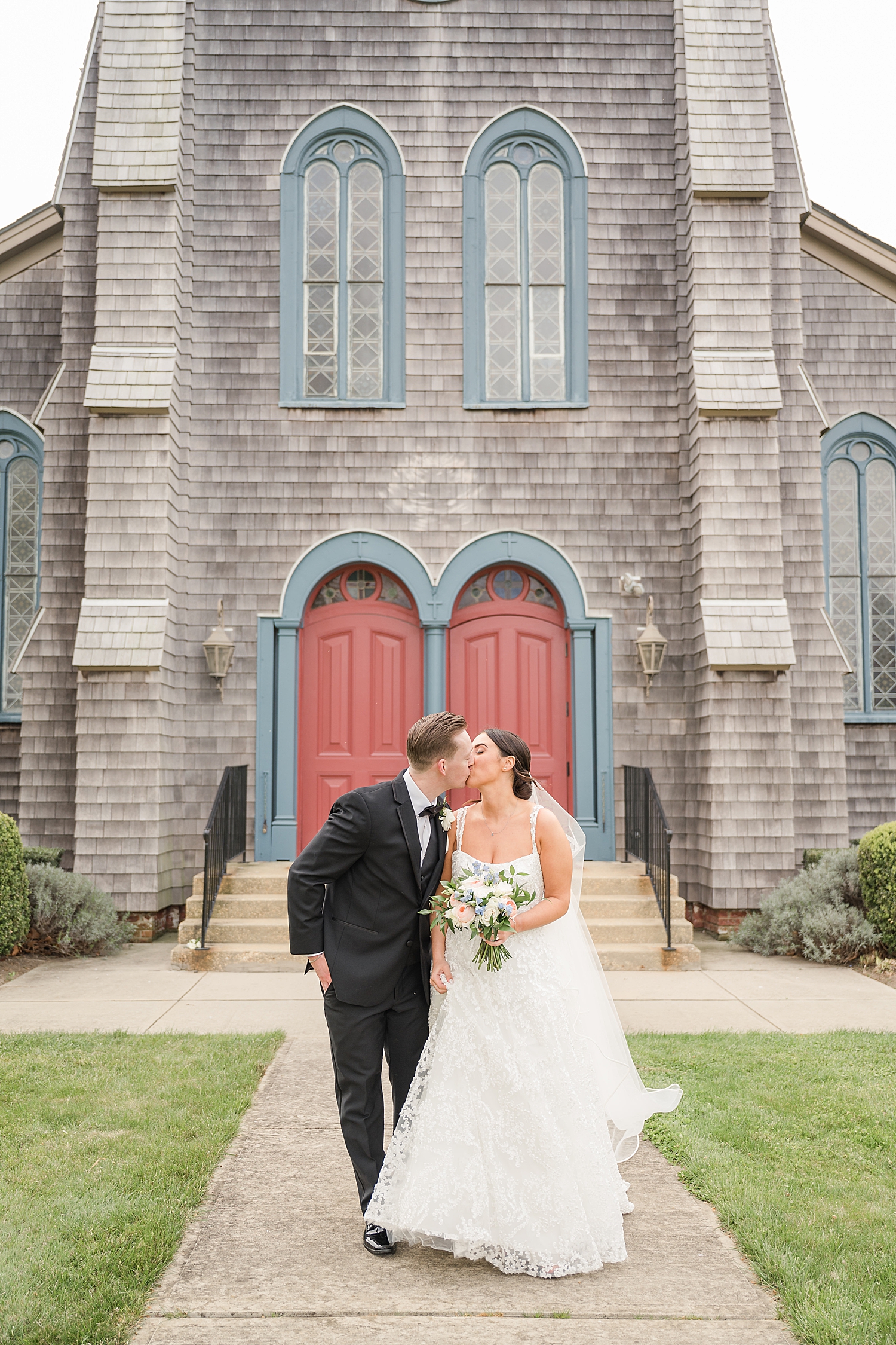 bride and groom kiss outside of church in New Jersey 