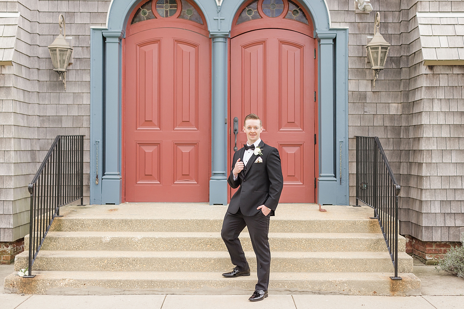 groom on church stairs in NJ